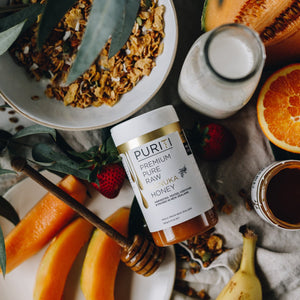 Puriti Premium Pure Raw Manuka Honey UMF 15+ 250g 8.8oz Jar, set amongst a fruit and granola board