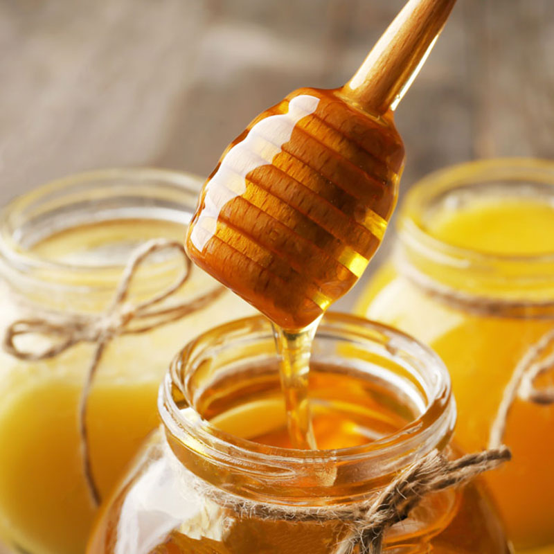 Puriti Honey dripping into a jar